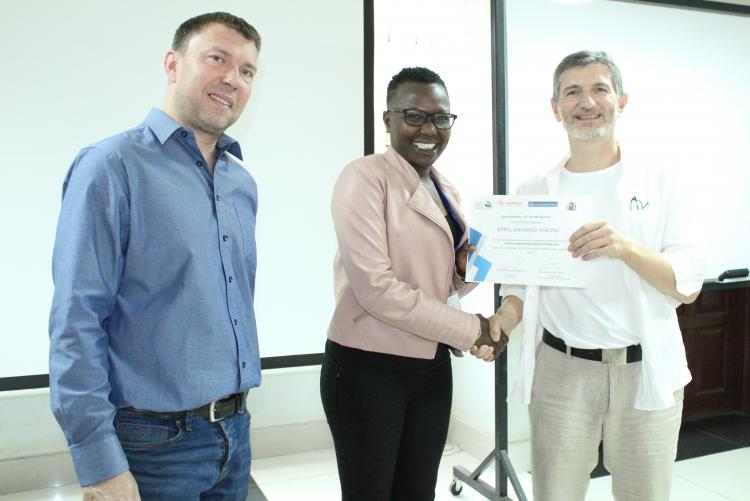 Berly Onyango happy to recieve her certificate from Prof Bernard Rachet